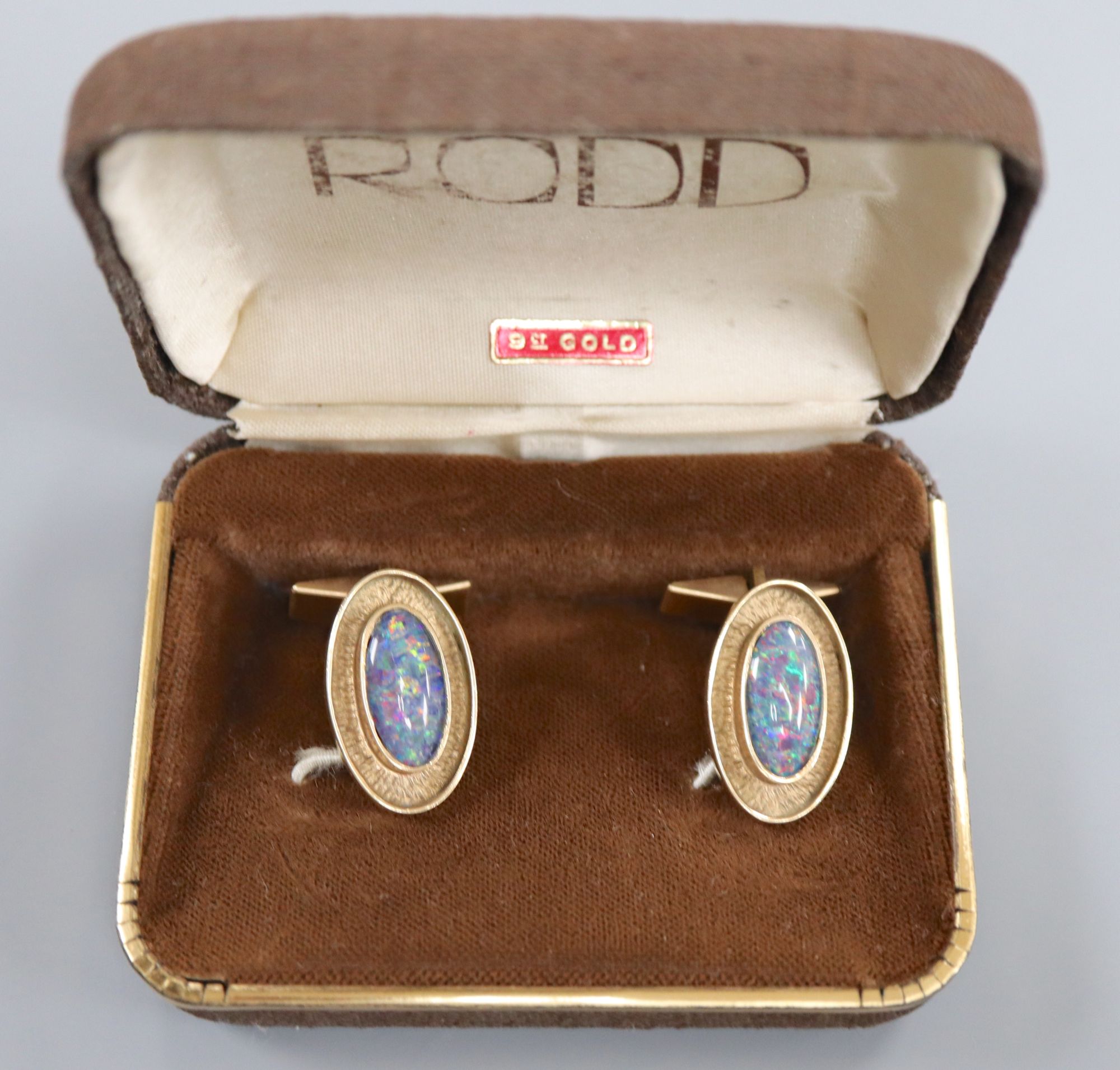 A pair of 9ct gold and opal doublet? set oval cufflinks, 24mm, gross 12.6 grams.